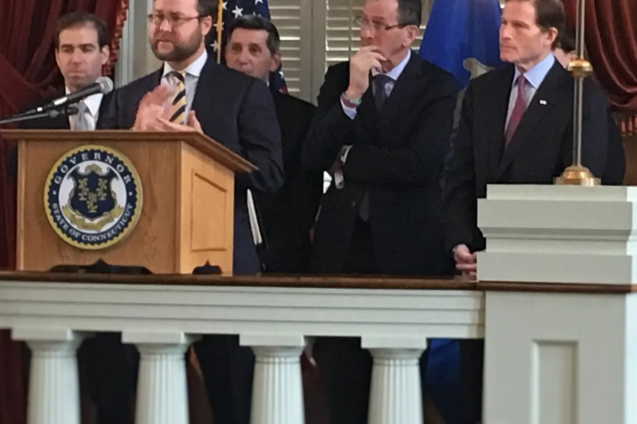 Director Wilkinson at press confernce with CT Governor Malloy, Senator Blumenthal, Hartford Mayor Bronin, and White House Drug Policy Director Botticelli "David Wilkinson, the director of the White House Office of Social Innovation, speaking at the Old State House about a new Pay for Success initiative to help parents with drug problems." With him are Hartford Mayor Luke Bronin, Director of National Drug Control Policy Michael Botticelli, Gov. Dannel P. Malloy and U.S. Sen. Richard Blumenthal.