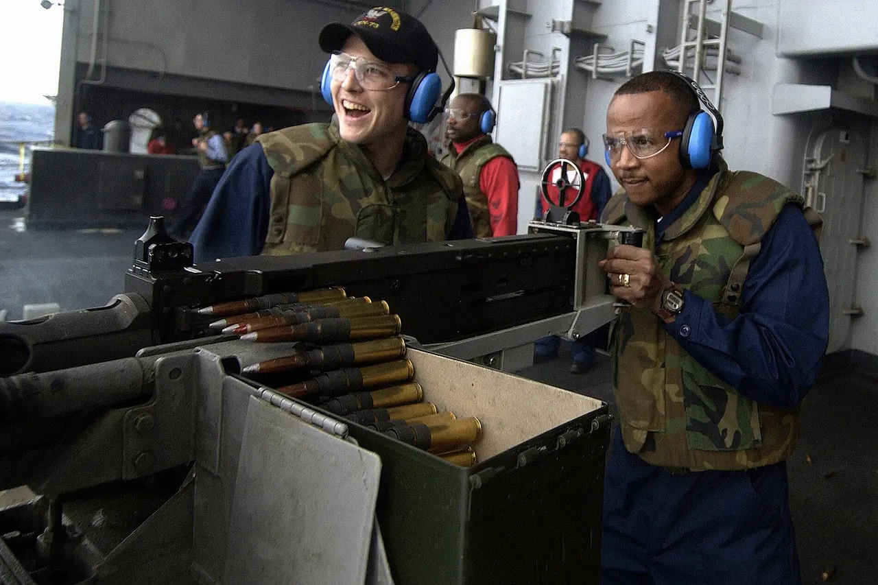 Atlantic Ocean (Jan. 25, 2004) – Gunner’s Mate 3rd Class Andrew Smith from Weatherford, Texas, looks on as Chief Gunner’s Mate Donald Watkins fires a 50. Caliber machine gun off the fantail aboard USS George Washington (CVN 73) during familiarization training, for the Force Protection Team. The Norfolk, Va. based nuclear powered aircraft carrier is on a regularly scheduled deployment. U.S. Navy photo by Photographer’s Mate 1st Class Brien Aho. (RELEASED)