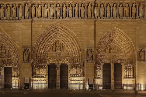 Lower part of the front façade of the Notre-Dame Cathedral, in Paris, at night. On the upper part, the 28 kings of Judea and Israel. On the lower part, from left to right, the portal of the Virgin, the portal of the Last Judgement, and the portal of Saint-Anne. This picture is a mosaic of 12 photos (4x3) taken with a Canon EOS 400D+EF-S 17-55mm f/2.8 IS, at 55mm, f/8.0, 6 sec and ISO 100. Stitching was done with Hugin and Enblend.