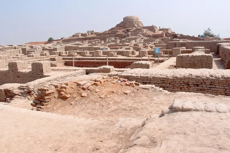 A view of the Buddhist stupa in the background located in the higher settlement to the west, generally referred to as the citadel mound, and it is mostly comprised of the ruins of ancient administrative buildings constructed on top of a massive mud-brick platform.