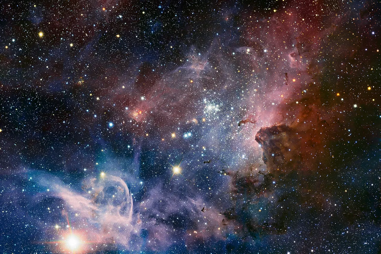 This broad panorama of the Carina Nebula, a region of massive star formation in the southern skies, was taken in infrared light using the HAWK-I camera on ESO’s Very Large Telescope. Many previously hidden features, scattered across a spectacular celestial landscape of gas, dust and young stars, have emerged. Some of these features have been annotated in Commons . Trumpler 16 (annotated) is an open cluster that contains the luminous, massive blue variable Eta Carinae, one of the brightest stars in the galaxy, possibly as much as 120 times the mass of the Sun, and emitting the light of 4,000,000 Suns. Eta Carinae is nearing the end of its life, and is surrounded by a huge nebula, cast off by numerous eruptions of the star over the last several centuries; it is expected to explode into a supernova at any time. Trumpler 14 (annotated) contains the huge double star HD 93129 A/B. The young O3 class star HD 93129 A is one of the brightest stars in the galaxy that is still on the main sequence, and with a luminosity equivalent to 3,000,000 Suns, is very nearly as bright as Eta Carinae, but this is not obvious in the photo due to obscuring nebulosities.