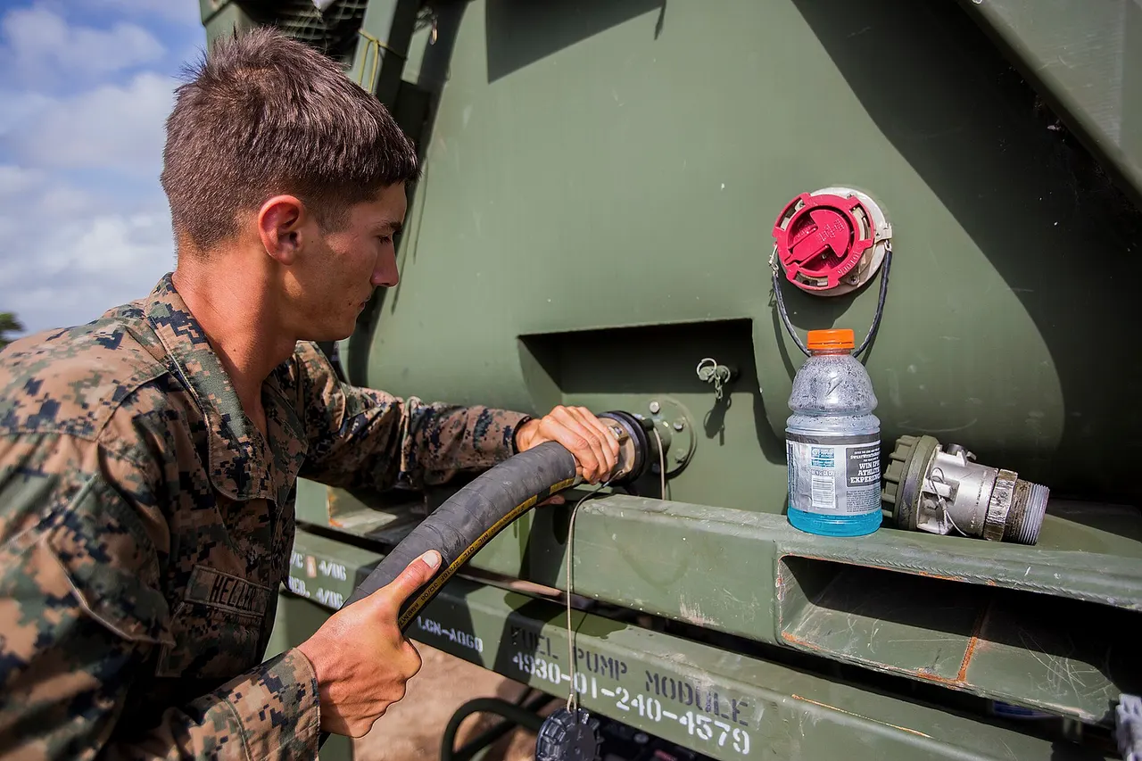 U.S. Marine Corps Lance Cpl. Derek Heller, a water purification specialist with Special Purpose Marine Air-Ground Task Force-Southern Command hooks a hose up to a fuel tank in Puerto Lempira, Honduras, Aug. 6, 2015. SPMAGTF-SC is a temporary deployment of Marines and Sailors throughout Honduras, El Salvador, Guatemala, and Belize with a focus on building and maintaining partnership capacity with each country through shared values, challenges, and responsibility. (U.S. Marine Corps Photo by Cpl. Katelyn Hunter/Released) Unit: U.S. Marine Corps Forces, South